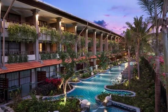The 109-metre lagoon pool at Bali Dynasty Resort, with sun lounges and rooms opening straight onto the water