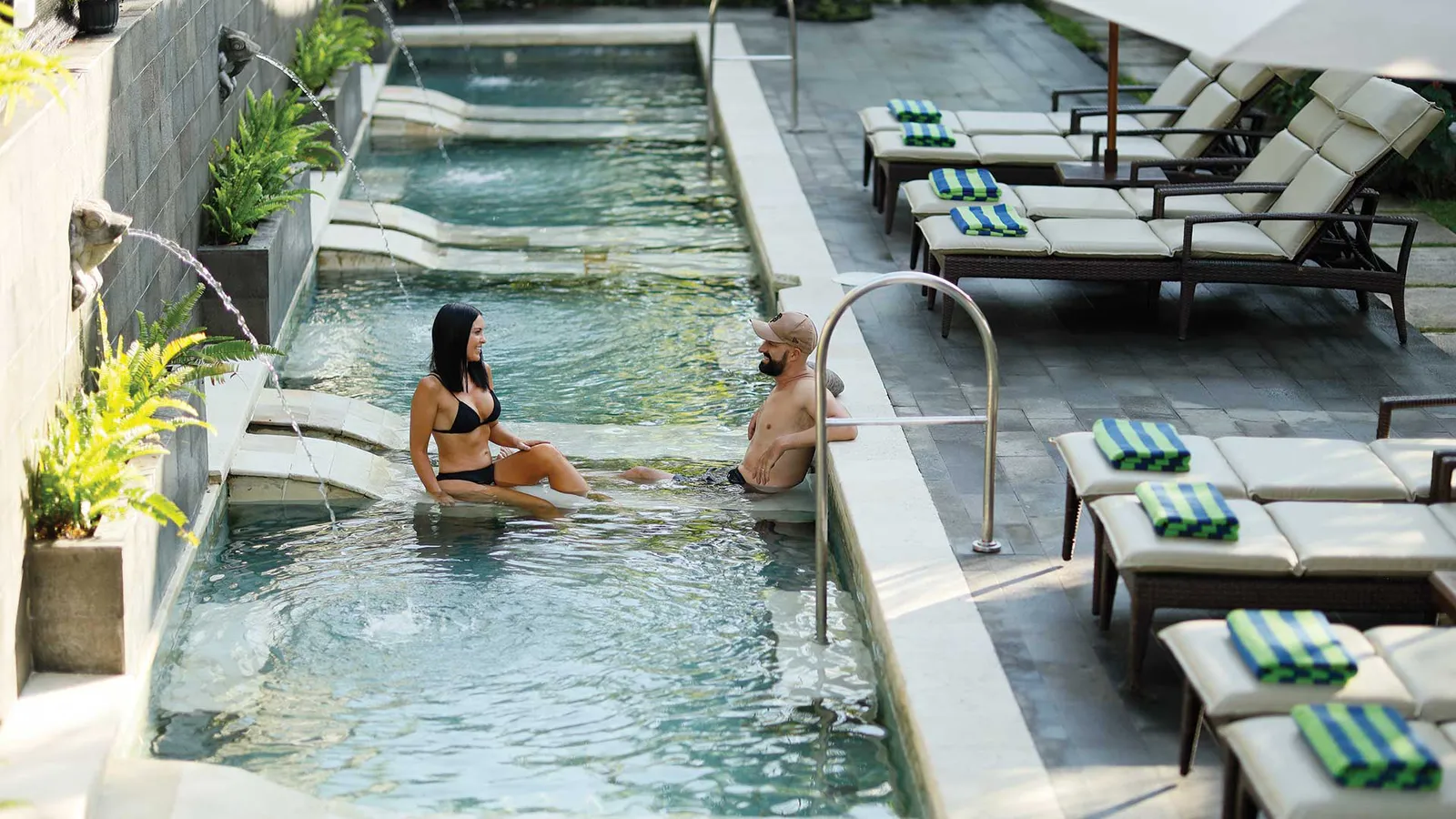 The adults-only Lazy Pool at Bali Dynasty Resort, with sun lounges and palms, near the spa