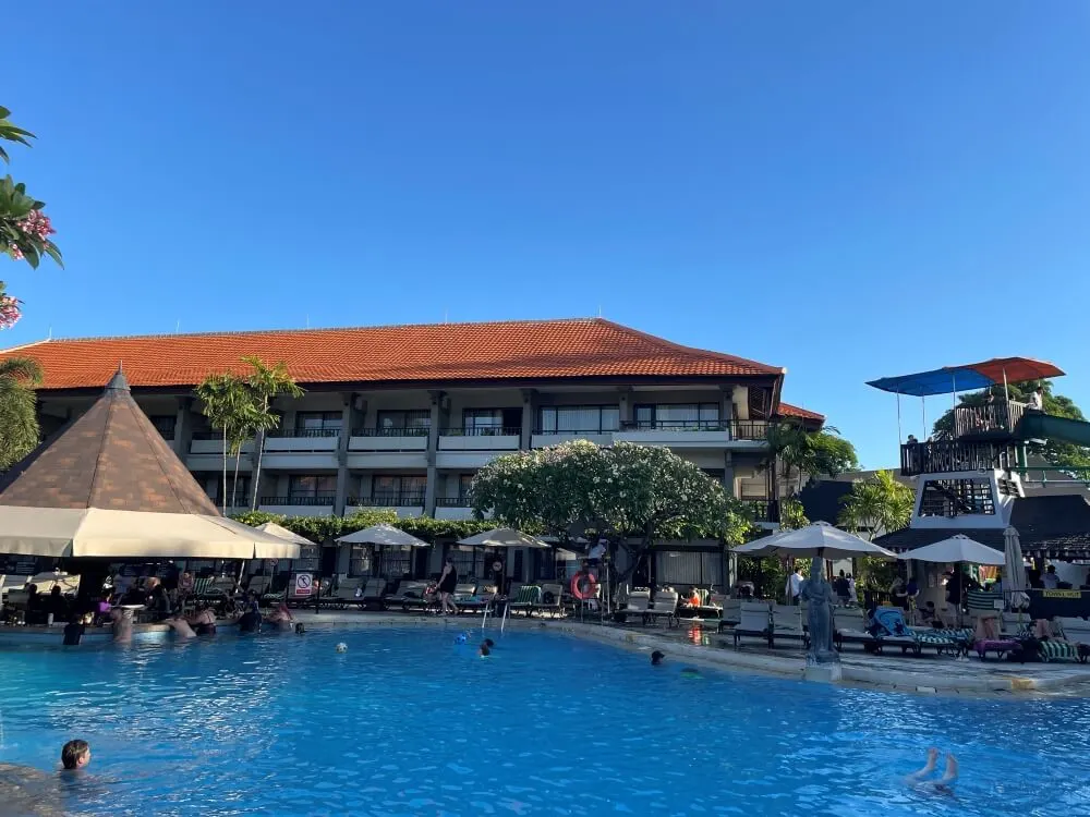 The main resort pool at Bali Dynasty Resort, with a swim-up bar and surrounding sun lounges