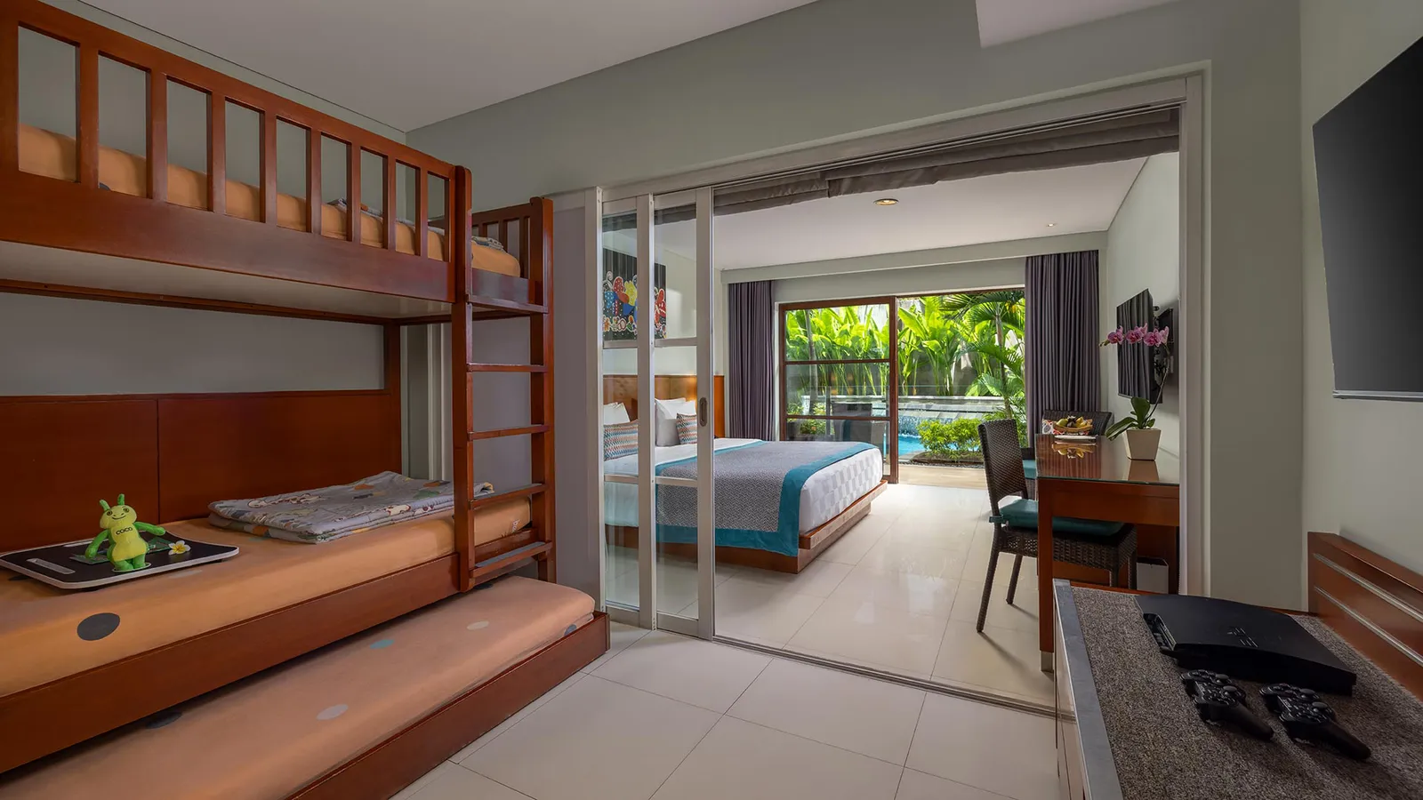 A Family Lagoon Pool Access room showing the children's bunk beds and the doors out to the pool terrace