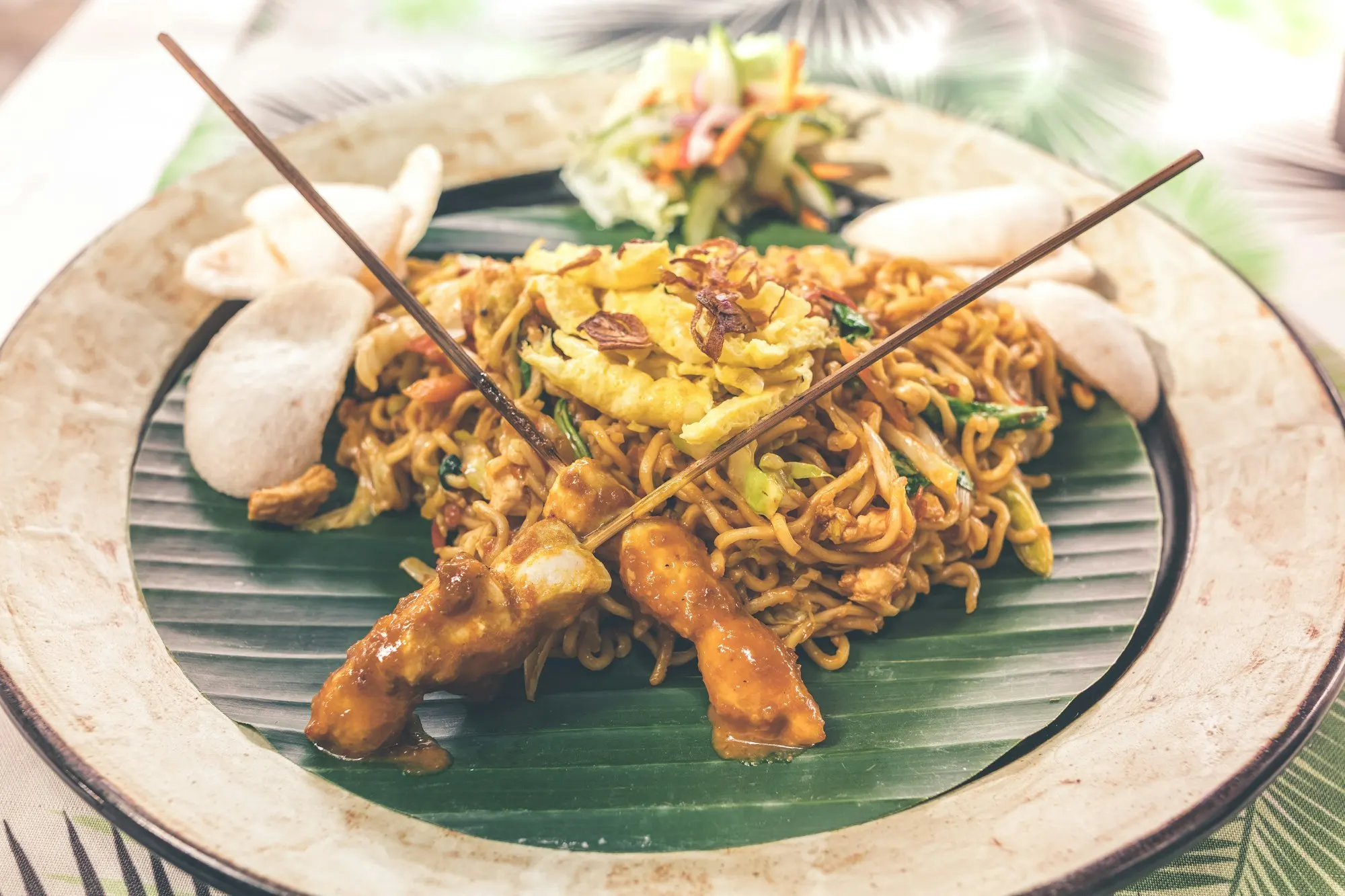 Bright and colourful Balinese dishes on a wooden table