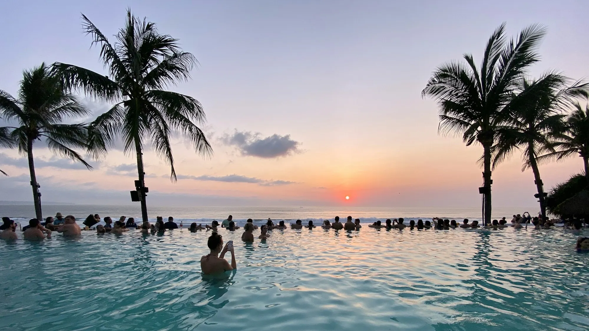 A resort pool with water slides at golden hour